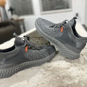 Gray women’s athletic shoes with orange accent. Never worn. Size 8.